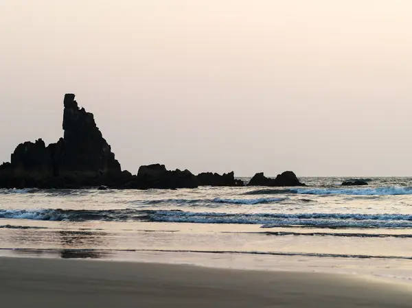 Horizontal dusk ocean rock tidal waves background backdrop