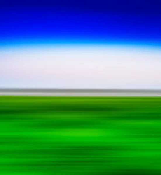 Square vivid green landscape with blue sky  motion blur abstract — Stock Photo, Image