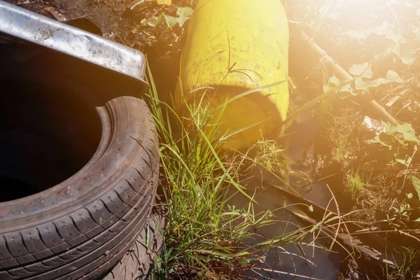 Dumped old fuel tanks and car repair parts damage the environment