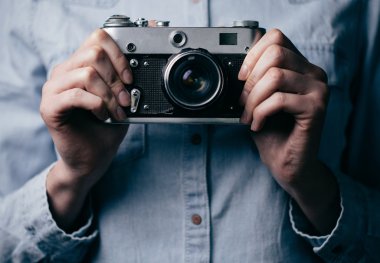 Kadınların elleri ile karanlık uzayda bir eski fotoğraf makinesi