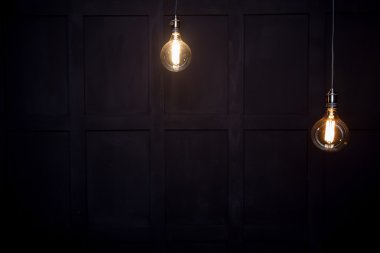  antique edison style light bulbs against wall  clipart