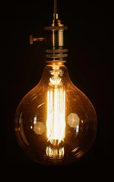 Vintage light bulb over dark — Stock Photo, Image