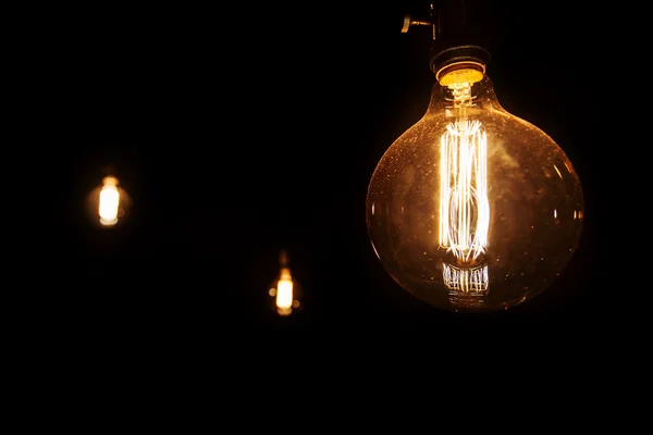 Light bulb on black background — Stock Photo, Image