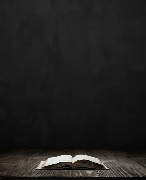 Bible over dark room background — Stock Photo, Image