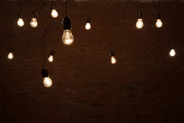 Light bulbs over brick all texture — Stock Photo, Image