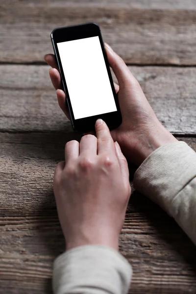 Hand holding smart phone on wooden background — Stock Photo, Image