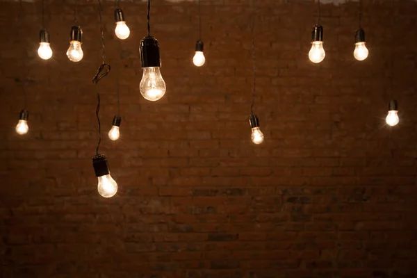 Light bulbs over brick all texture — Stock Photo, Image