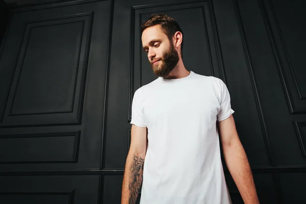 blank t-shirt with space for your logo on a hipster man with a b