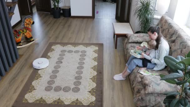 Robô Aspirador Limpeza Uma Sala Estar Enquanto Mãe Uma Criança — Vídeo de Stock
