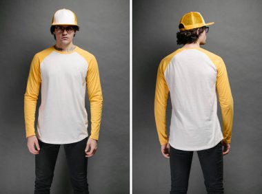 Beyaz ve sarı, boş, uzun kollu gömlek giyen bir erkek manken ve gri arka planda logonuz veya tasarımınız için geniş bir beyzbol şapkası.