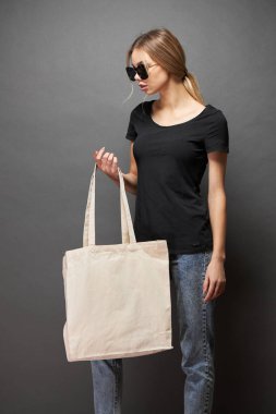Model için taşıma çantası gri dokuya sahip bir kadın tarafından tutulur.