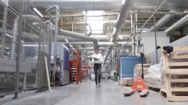 Marangoz fabrikasındaki iş kadını tablet bilgisayar kullanıyor. Marangozluk fabrikası. Parke tahtası üretimi için bir fabrika