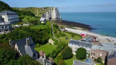 Etretat, Fransa - güneşli bir günde kıyısı ve okyanusu olan güzel kıyı şeridi ve kaymak kayalıkları manzarası