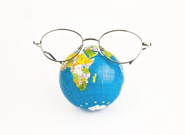Globe looking through the glasses — Stock Photo, Image