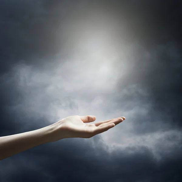 Ręka na zachmurzone niebo burzliwy — Zdjęcie stockowe