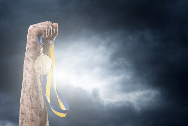 Hand holding medal