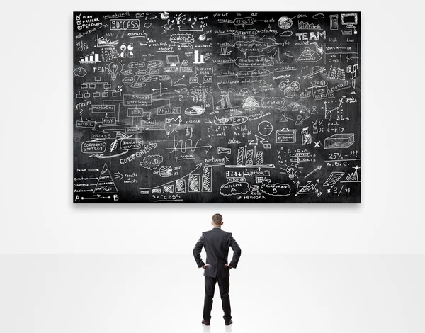 Businessman posing over sketches — Stock Photo, Image