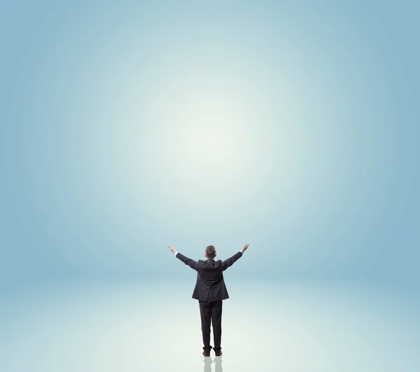 Businessman backwards over blue background — Stock Photo, Image