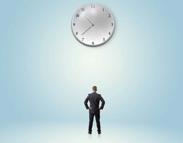 Businessman backwards looking at clock — Stock Photo, Image