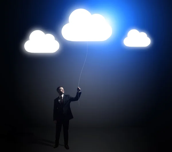 Businessman with idea clouds — Stock Photo, Image