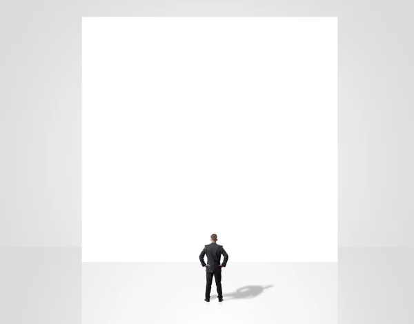 Businessman posing over poster — Stock Photo, Image
