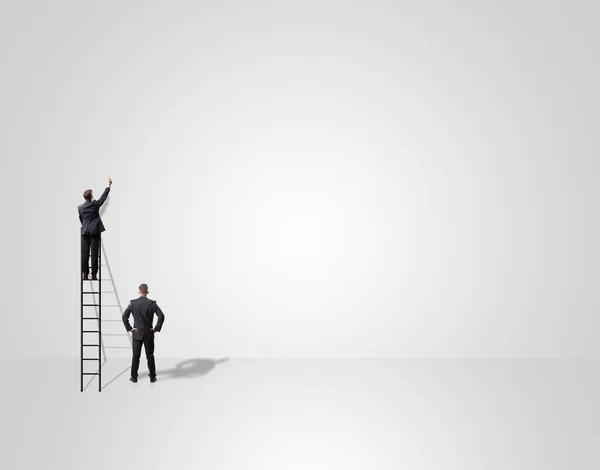 Businessman on ladder over wall — Stock Photo, Image