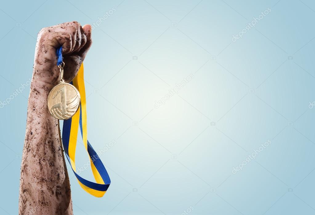 Hand holding medal