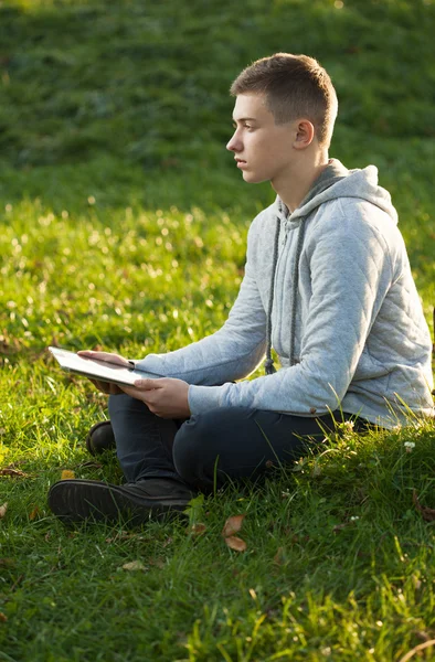 Jongen met tablet pc in het park — Stockfoto
