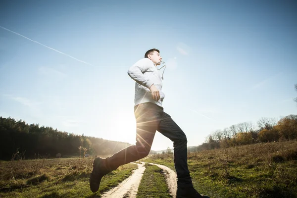 Teenager running in park — Stock Photo, Image