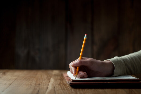 Woman's hand writing on paper