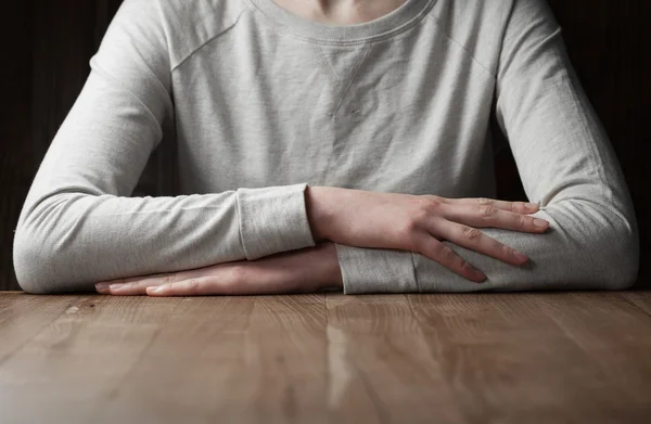 Woman arms folded over table — Stock Photo, Image