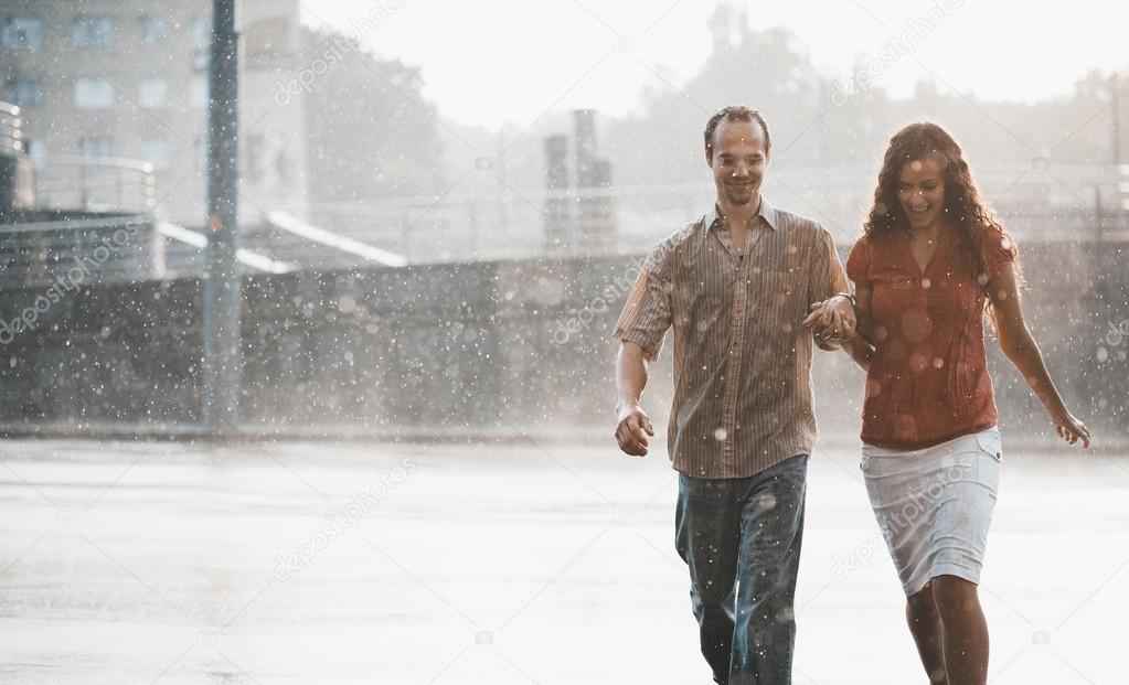 Couple in love under summer rain