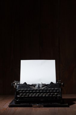 Typewriter on a wooden table clipart