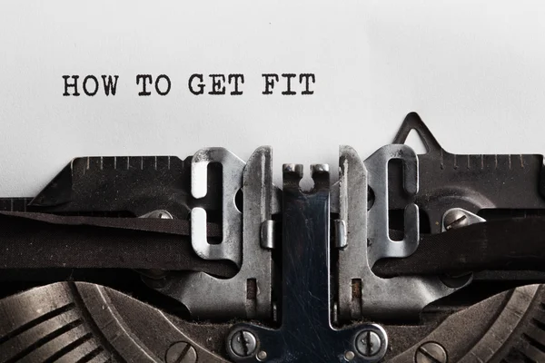 Get fit slogan on the sheet of a paper written by typewriter — Stock Photo, Image