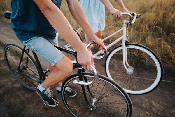 young couple on vintage bikes riding