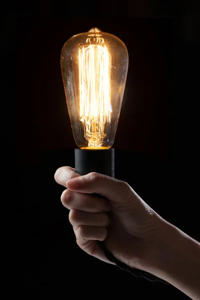 Hand holding classic Edison light bulb — Stock Photo, Image