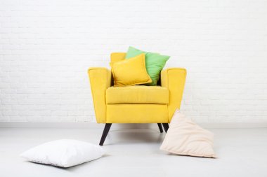 White wall texture with a retro yellow armchair clipart