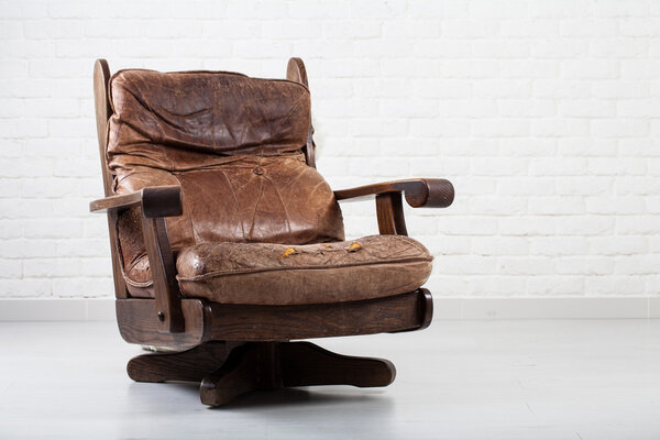 retro leather armchair next to a wall