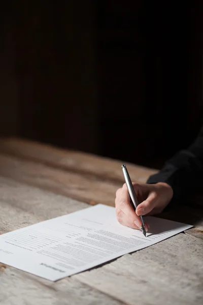 Vrouw hand ondertekening document — Stockfoto