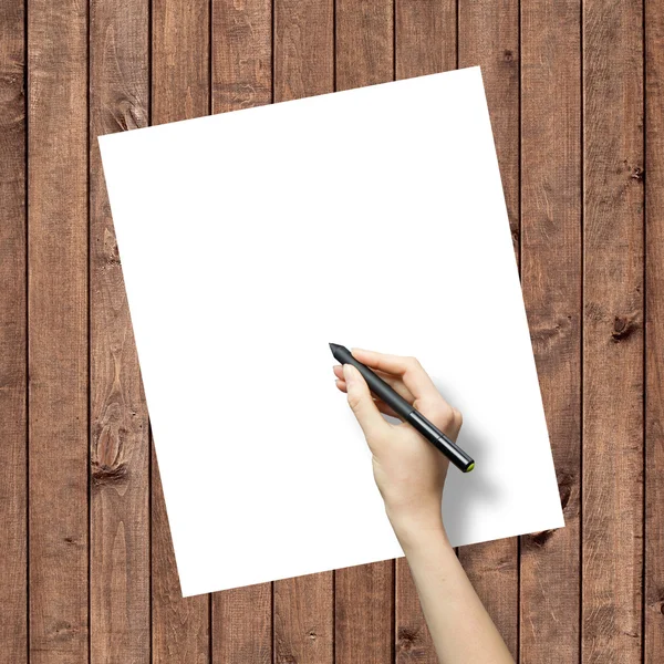 Hand drawing on white paper sheet with wooden texture background — Stock Photo, Image