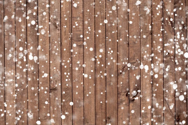 Jul bakgrund med fallande snö över trä bakgrund — Stockfoto