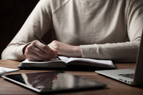 As mãos da mulher usando laptop e escrita na mesa de escritório — Fotografia de Stock