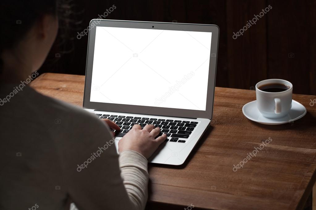 woman hands using laptop at office desk, with copyspace in dark