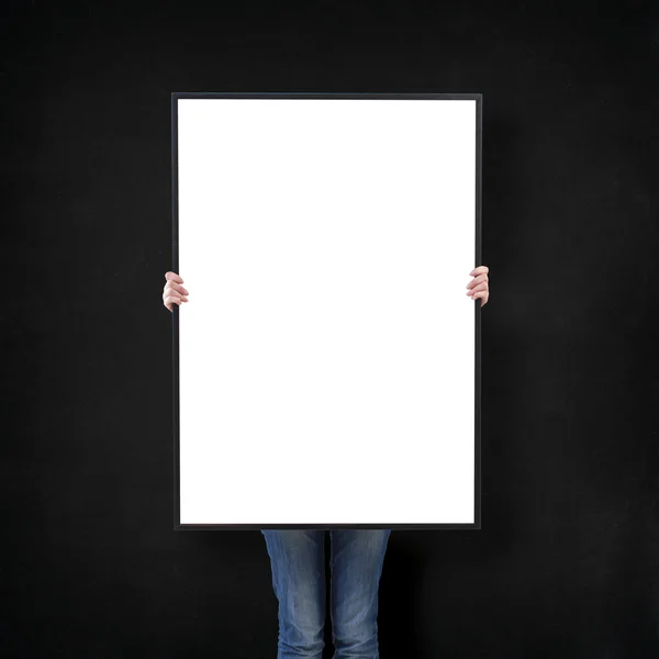 woman with blank poster on wall background