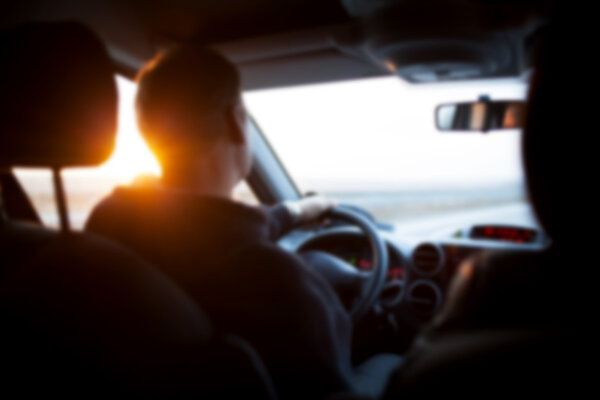 blurred image of a driver traveling on a road