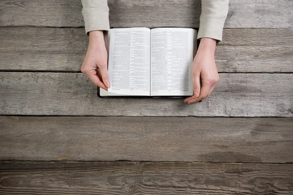 Woman hands on bible. she is reading and praying over bible over — Stock Photo, Image