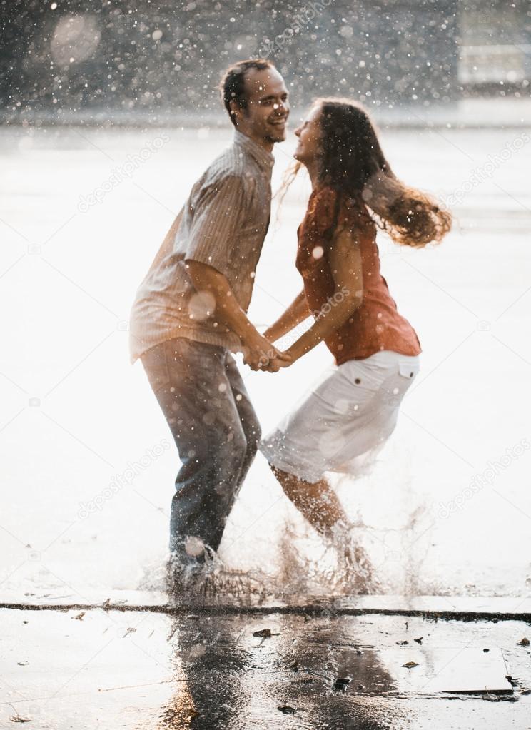 couple having fun under the rain. Blurred image effect