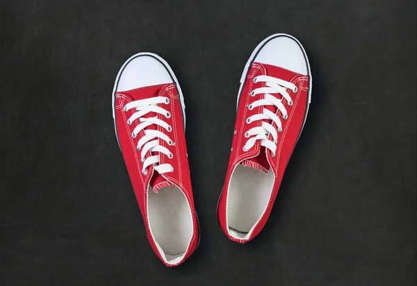 Red shoes on black background with space for text — Stock Photo, Image