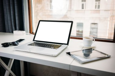 Ofis büro dizüstü ve tablet pc ve bir sma ile bir pencere yanında