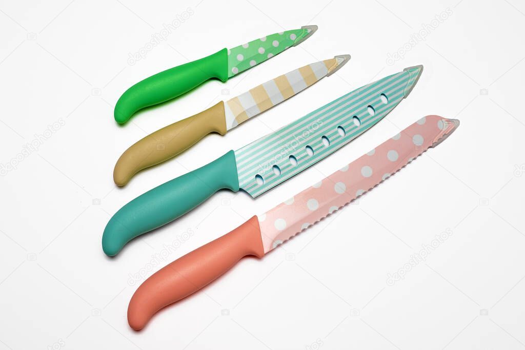 Set of colored painted stainless steel or ceramic kitchen knives isolated on white background. Top veiw